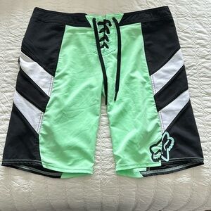 Fox youth size 7 sports shorts with zip pocket, lime, green, and black-white